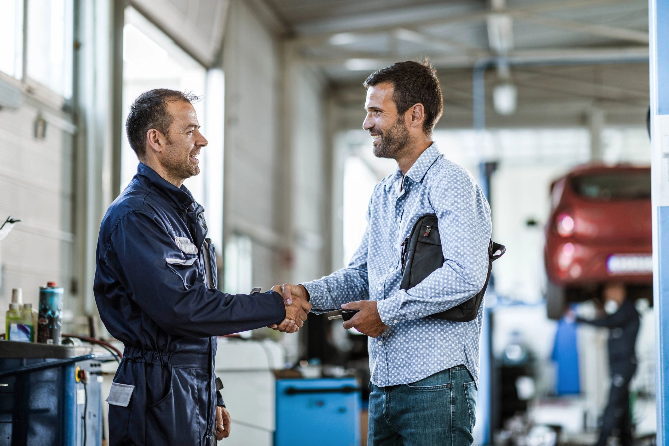 Mechanic shaking hands with a customer after service