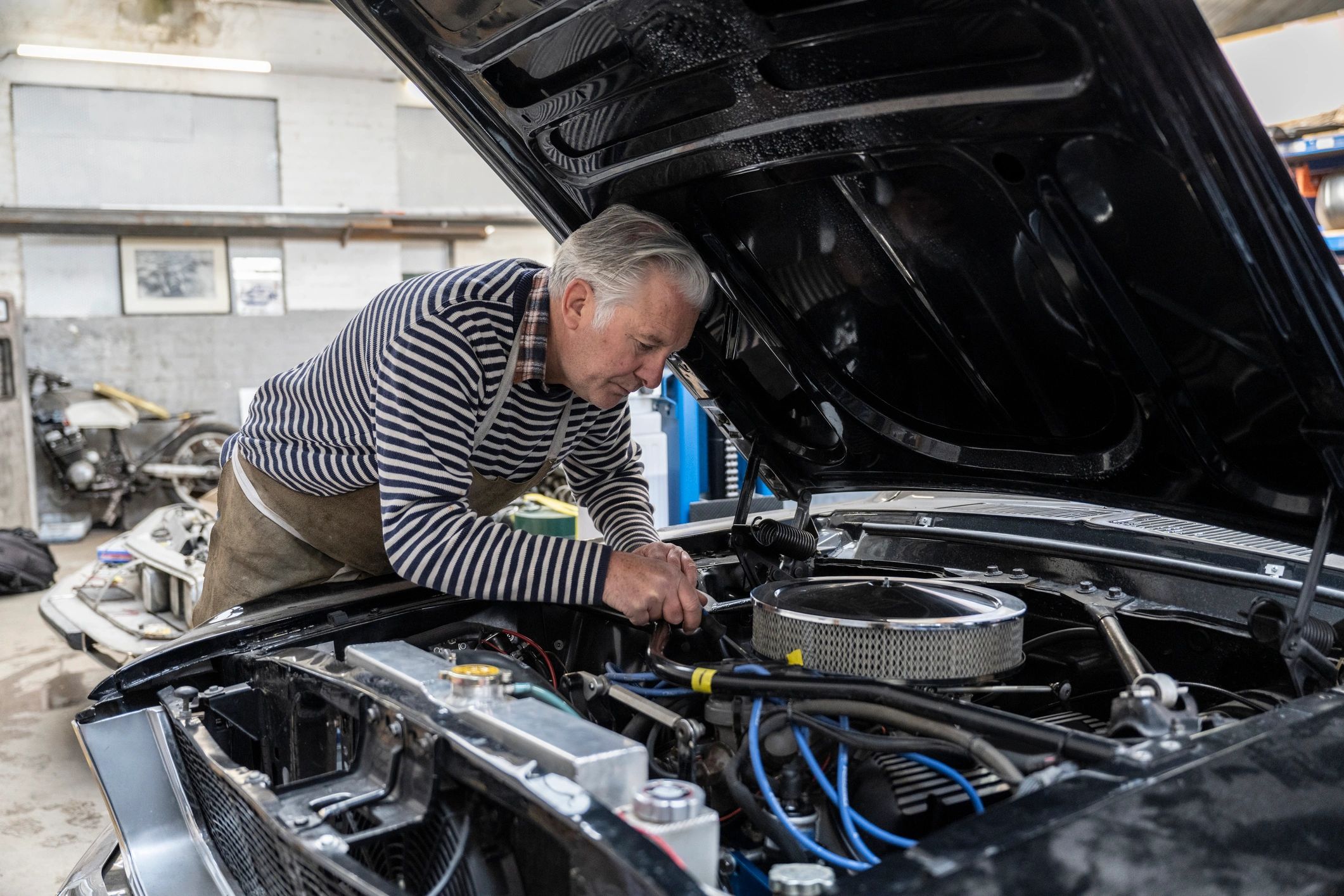 Mechanic working under the bonnet