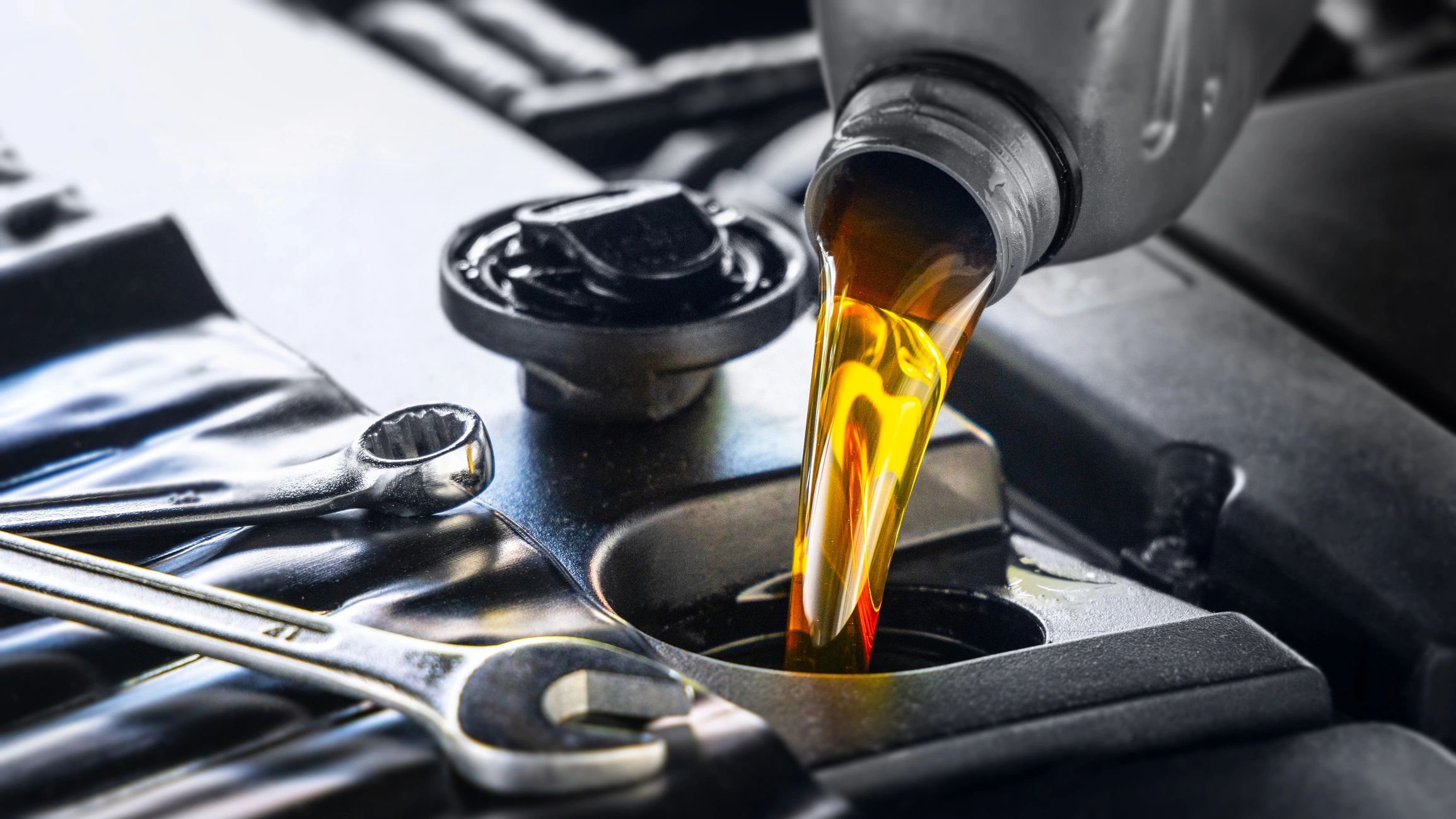 Pouring engine oil during a vehicle service