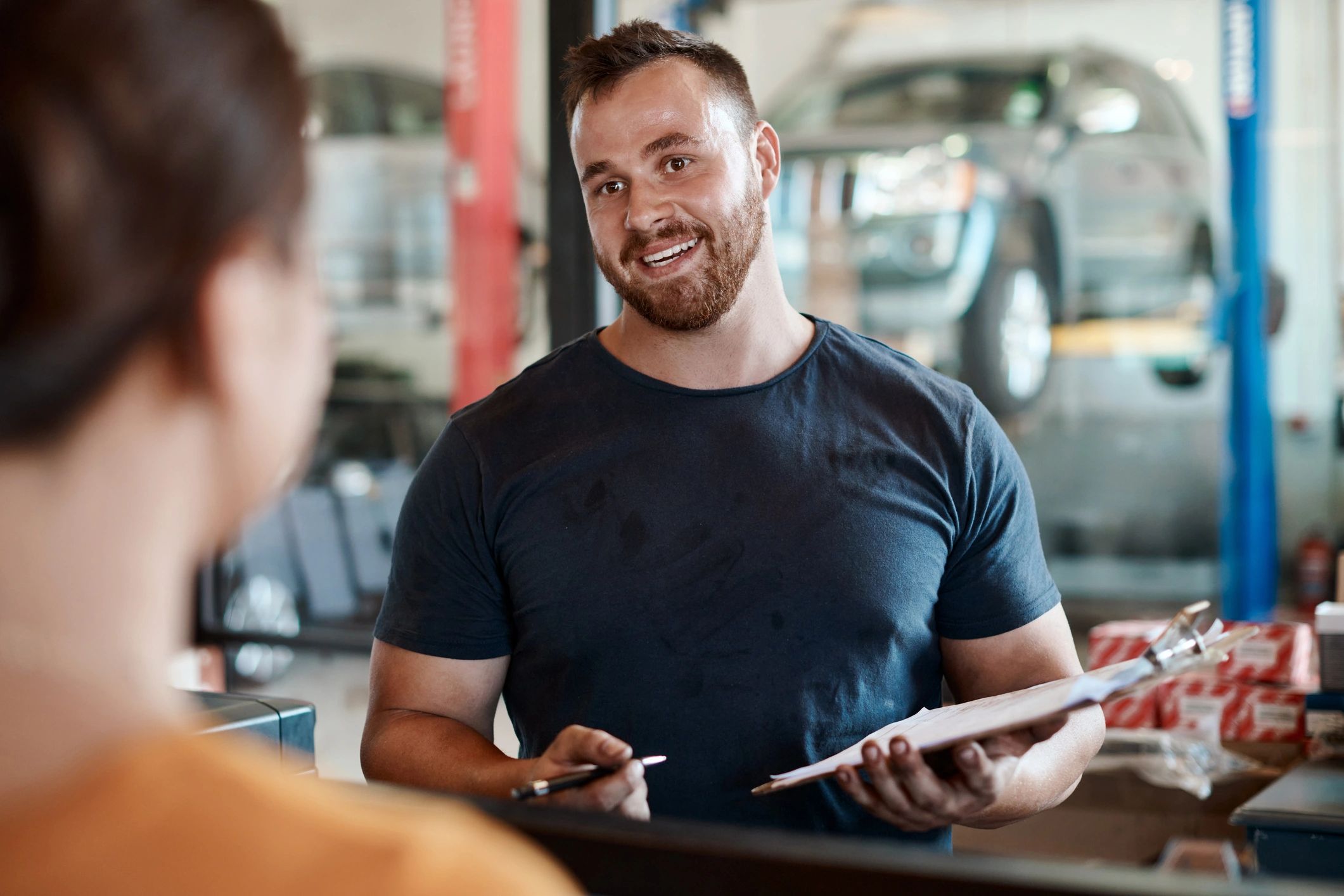 Customer speaking with a mechanic at a service desk