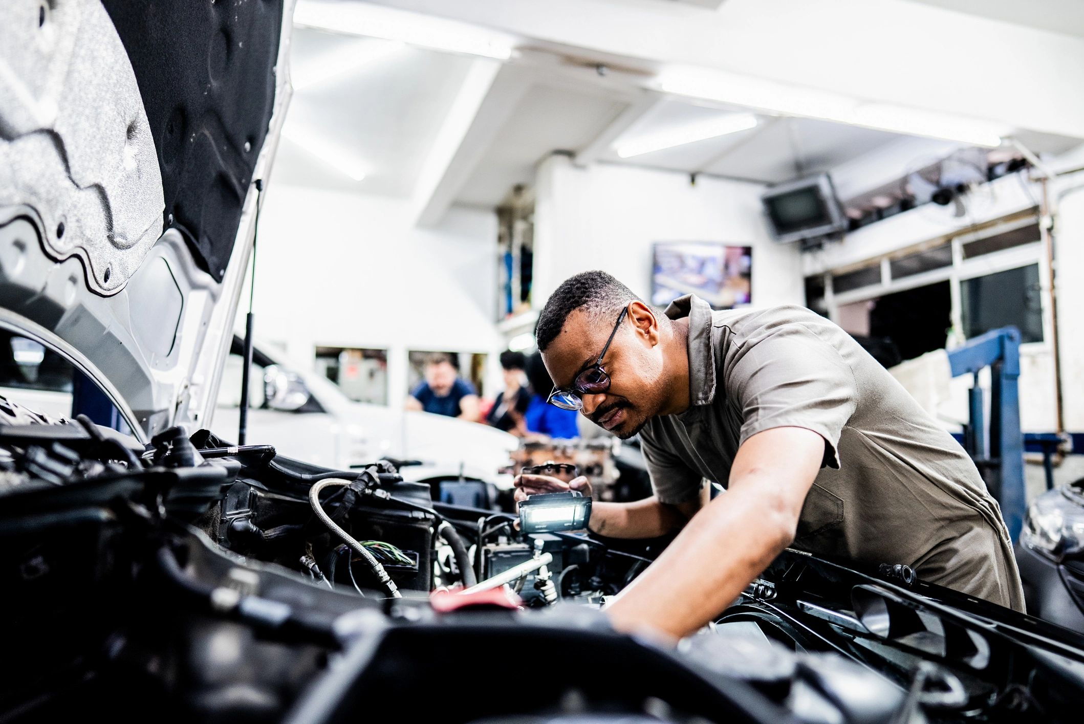 Mechanic inspecting a vehicle during servicing